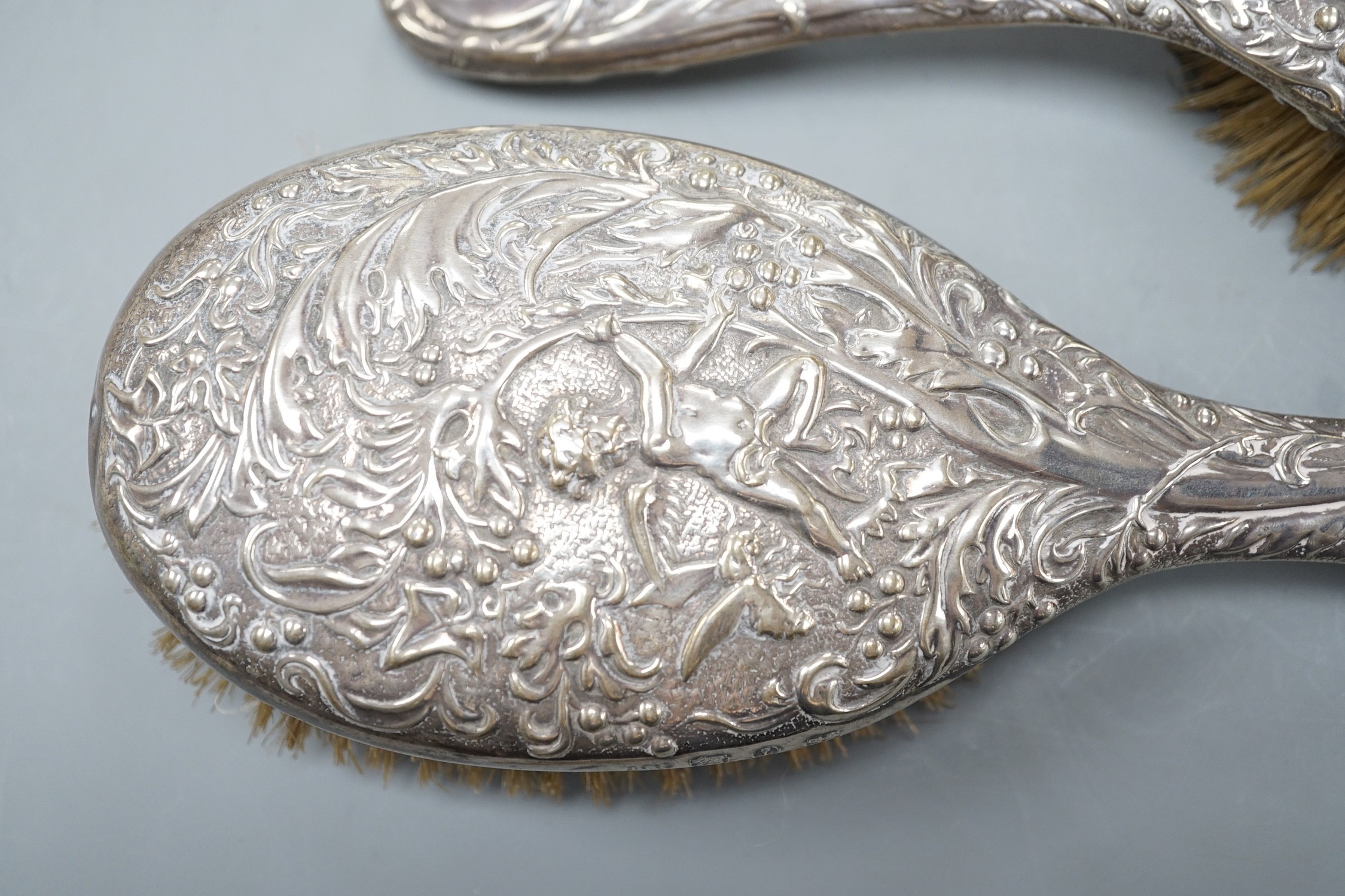 A pair of late Victorian repousse silver mounted hairbrushes, Birmingham, 1893.